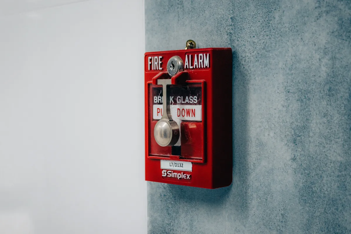Fire alarm pull station on wall